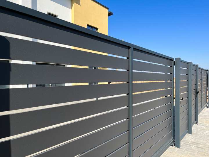 A metal fence gate installation that provides added security to a residential property.